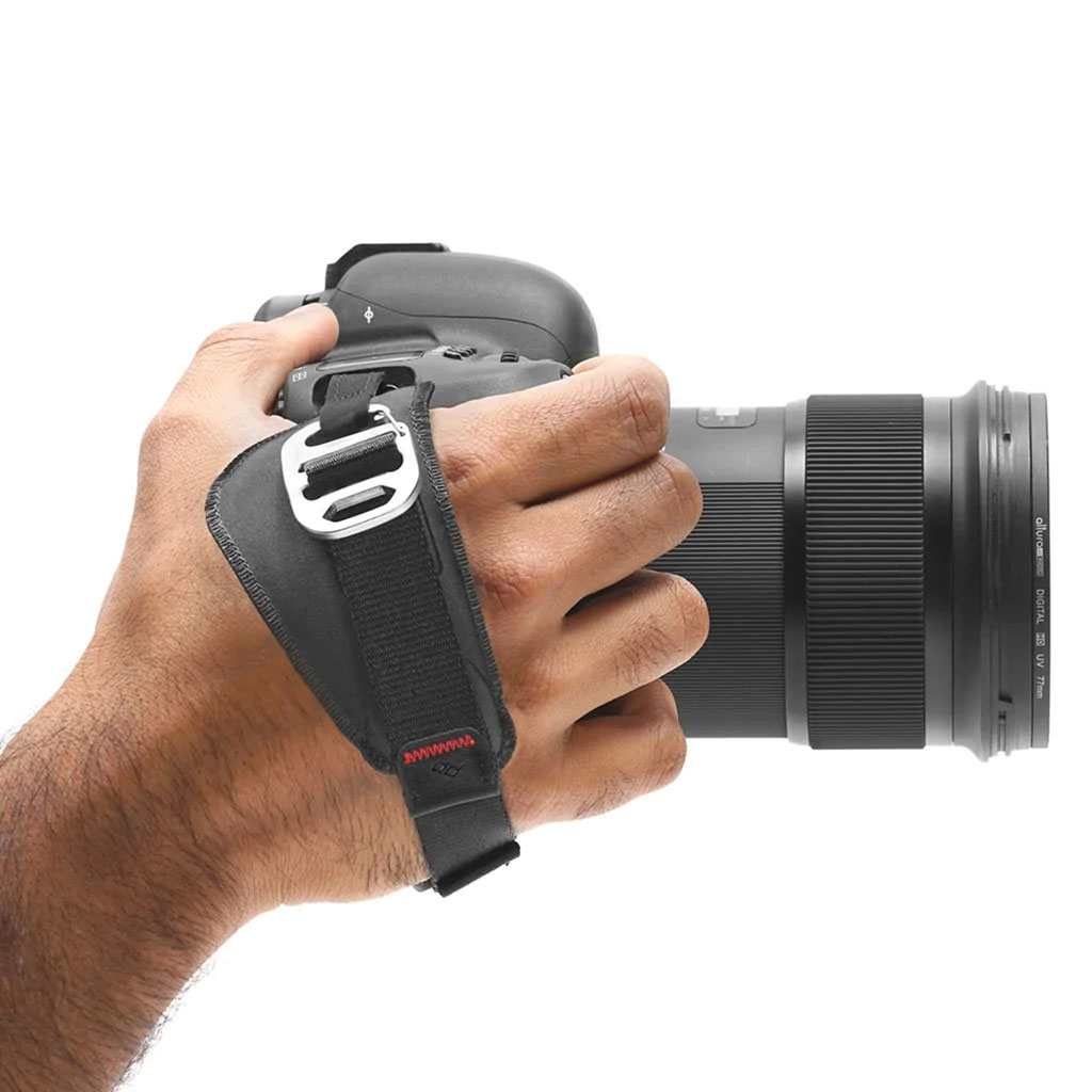 Peak Design Clutch attached to camera while being held in hand. 