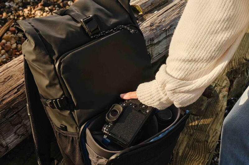 Tenba DNA backpack being open on a park bench. 