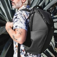 The Peak Everyday Backpack worn on a man's back. 