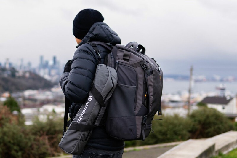 Vanguard Alta Sky backpack beind worn by man standing by road. 